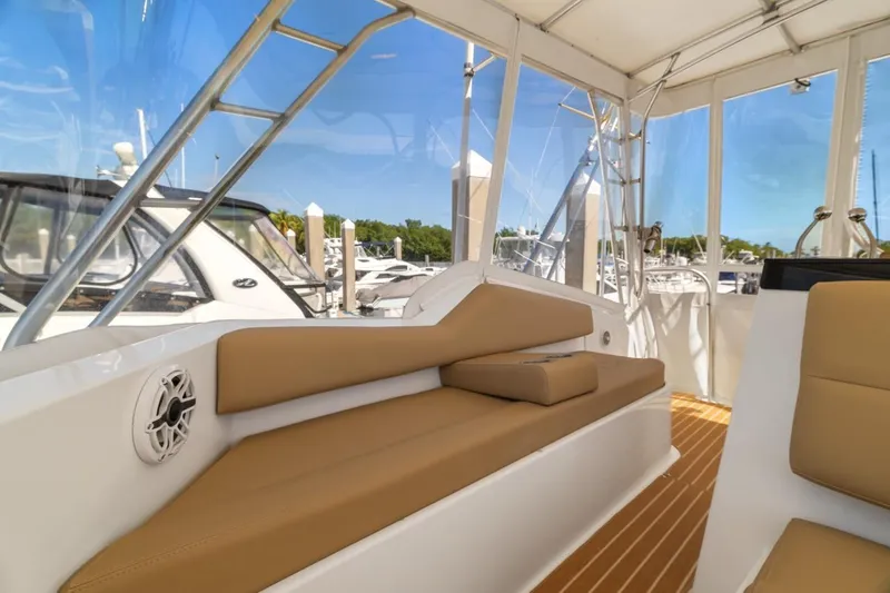Slide: The Image of 1978 Hatteras 45 Convertible yacht interior with tan seating and marina view. - 49