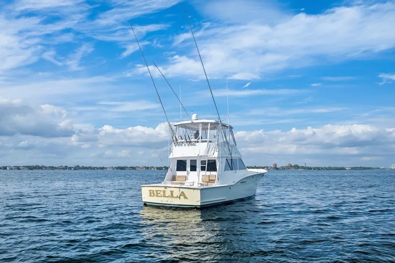 Slide: The Image of 1978 Hatteras 45 Convertible boat named "Bella" on open water under blue sky. - 5