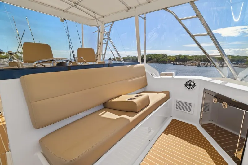 Slide: The Image of 1978 Hatteras 45 Convertible yacht interior with tan seating and scenic water view. - 50