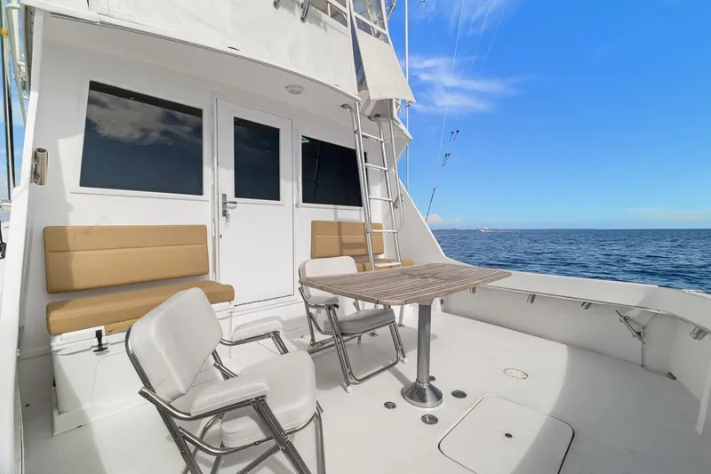 Slide: The Image of 1978 Hatteras 45 Convertible yacht deck with seating and ocean view. - 53