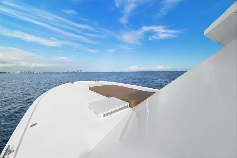 Slide: The Image of 1978 Hatteras 45 Convertible yacht on open water under clear blue sky. - 54