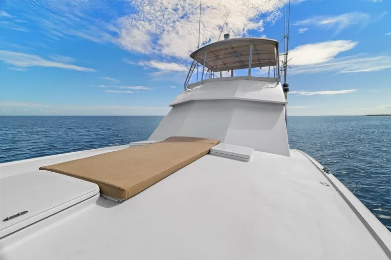 Slide: The Image of 1978 Hatteras 45 Convertible yacht on open sea under blue sky. - 55