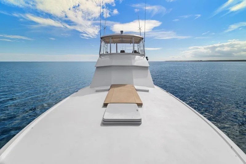 Slide: The Image of 1978 Hatteras 45 Convertible yacht on open sea under blue sky. - 56