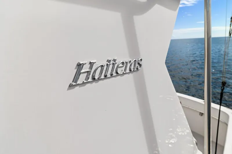 Slide: The Image of 1978 Hatteras 45 Convertible yacht on open water, showcasing brand logo. - 57
