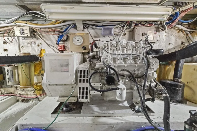 Slide: The Image of Engine room of a 1978 Hatteras 45 Convertible boat, showcasing detailed machinery. - 62