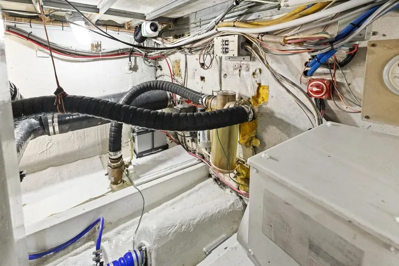 Slide: The Image of Engine room of 1978 Hatteras 45 Convertible with wiring and plumbing details. - 63