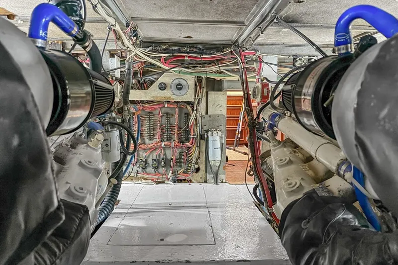 Slide: The Image of Engine room of a 1978 Hatteras 45 Convertible boat, showcasing wiring and machinery. - 65