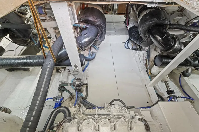 Slide: The Image of Engine room of a 1978 Hatteras 45 Convertible boat, showcasing mechanical components. - 66