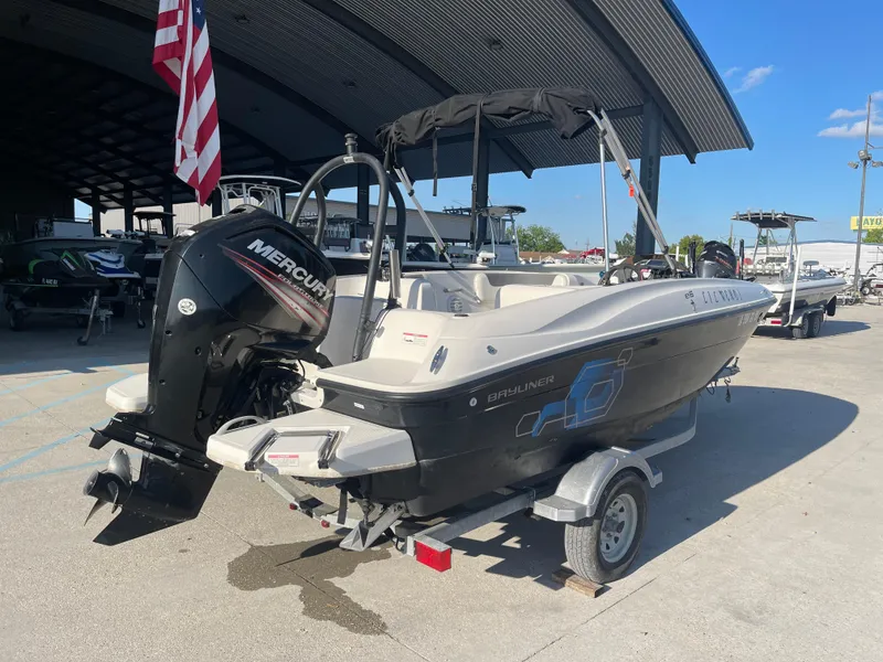 Slide: The Image of 2017 Bayliner Element E16 boat with Mercury engine on trailer, parked outdoors. - 1