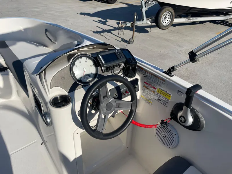 Slide: The Image of 2017 Bayliner Element E16 boat dashboard with steering wheel and controls. - 14