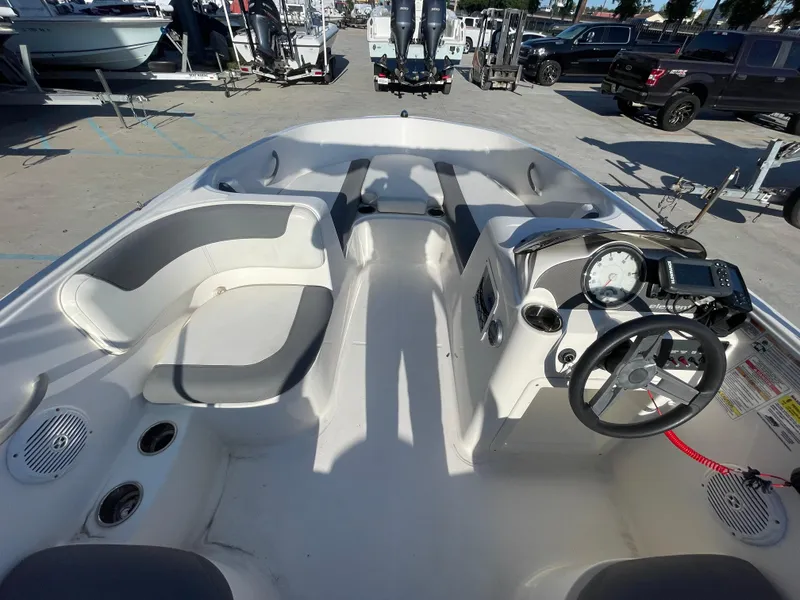 Slide: The Image of 2017 Bayliner Element E16 boat interior with steering wheel and seating. - 16