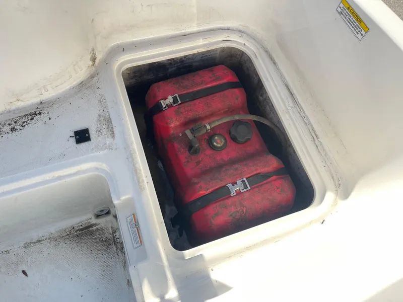 Slide: The Image of Red fuel tank in storage compartment of 2017 Bayliner Element E16 boat. - 28