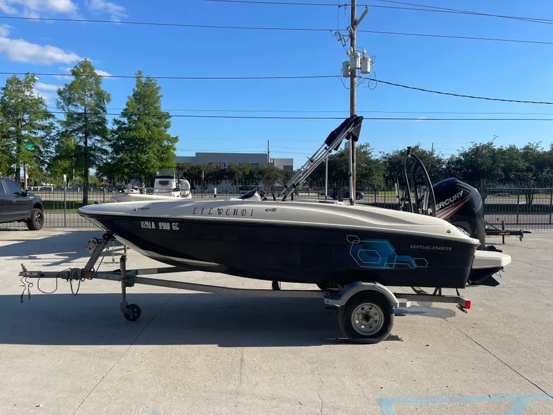 Slide: The Image of 2017 Bayliner Element E16 boat on trailer, parked outdoors under clear sky. - 3