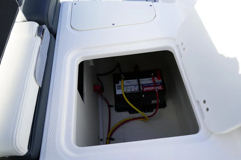 Slide: The Image of 2023 Chaparral 21 SSi OB boat battery compartment with visible wiring. - 11