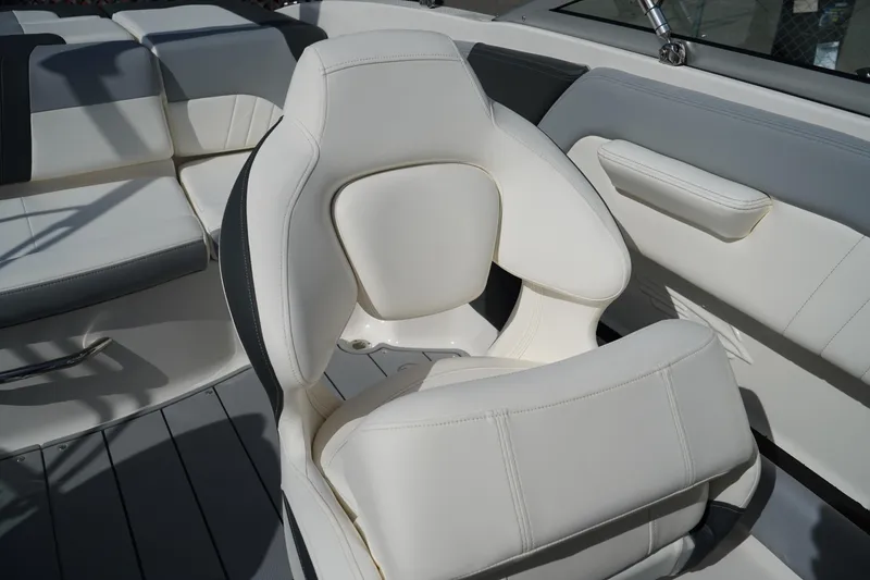 Slide: The Image of 2023 Chaparral 21 SSi OB boat interior with white cushioned seating. - 19
