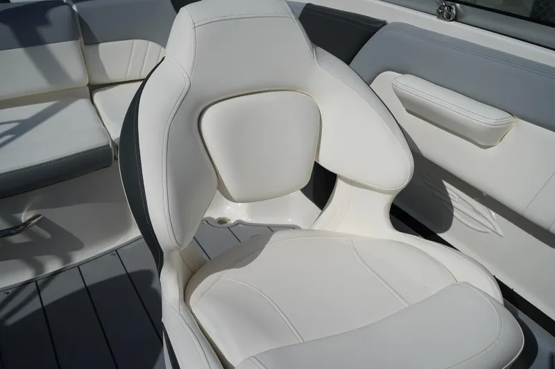 Slide: The Image of 2023 Chaparral 21 SSi OB boat interior with white cushioned seating. - 20