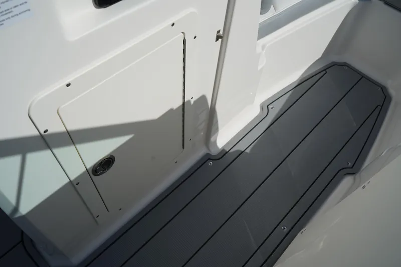 Slide: The Image of 2023 Chaparral 21 SSi OB boat interior with sleek gray flooring and storage compartment. - 34