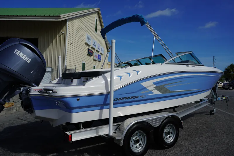 Slide: The Image of 2023 Chaparral 21 SSi OB boat on trailer, blue and white design, Yamaha outboard motor. - 8