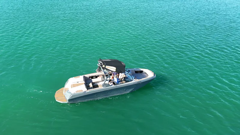Slide: The Image of 2018 Nautique Super Air Nautique G25 boat on clear turquoise water. - 15
