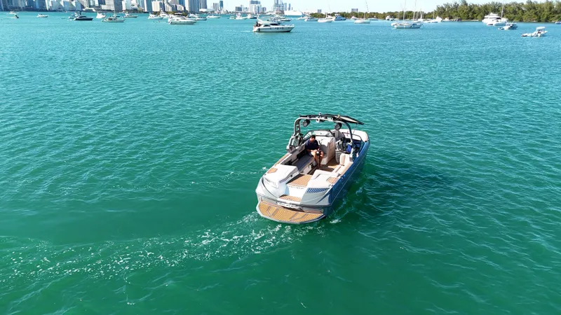 Slide: The Image of 2018 Nautique Super Air Nautique G25 on turquoise water, surrounded by boats. - 17