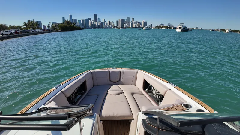 Slide: The Image of 2018 Nautique Super Air Nautique G25 on water with city skyline in background. - 30