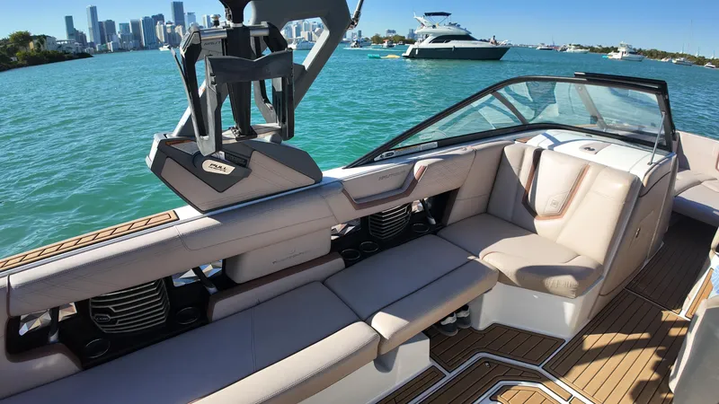 Slide: The Image of 2018 Nautique Super Air Nautique G25 interior with city skyline and boats in background. - 32