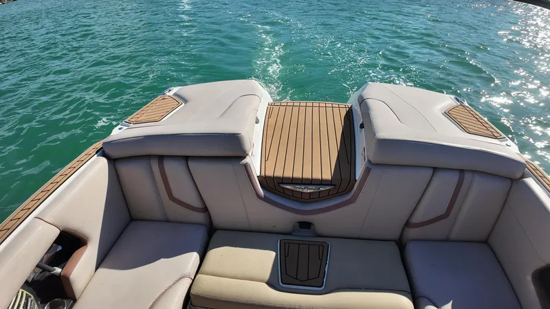 Slide: The Image of 2018 Nautique Super Air Nautique G25 boat interior with cushioned seating and teak flooring. - 39