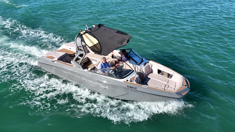 Slide: The Image of 2018 Nautique Super Air Nautique G25 cruising on clear blue water. - 4