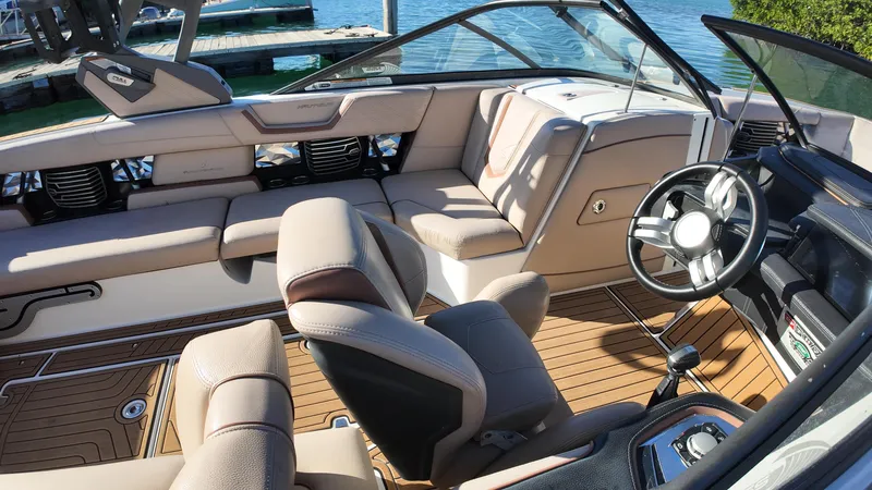 Slide: The Image of 2018 Nautique Super Air Nautique G25 interior with luxurious seating and modern steering wheel. - 40