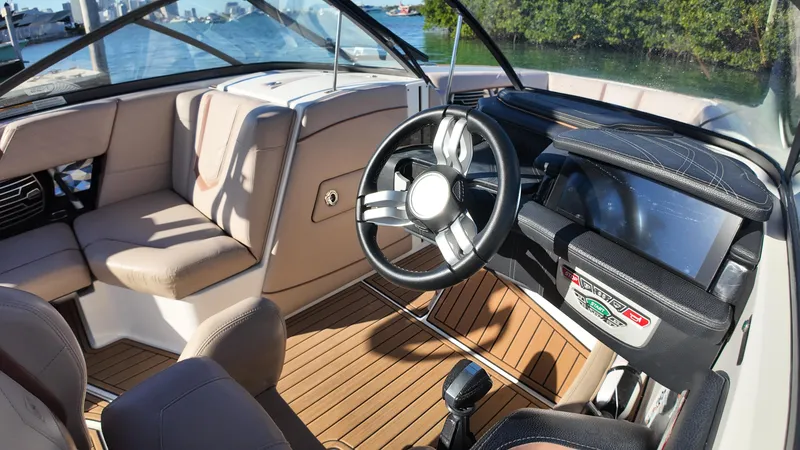 Slide: The Image of Interior of 2018 Nautique Super Air Nautique G25 boat with steering wheel and seating. - 41