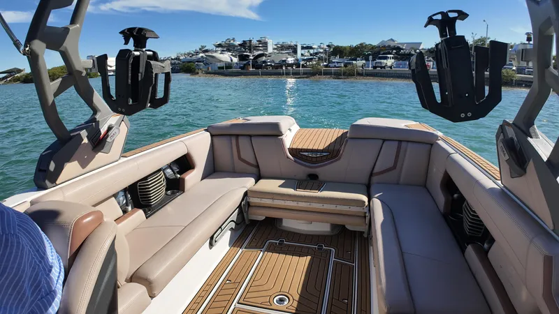 Slide: The Image of 2018 Nautique Super Air Nautique G25 interior with spacious seating and scenic waterfront view. - 45