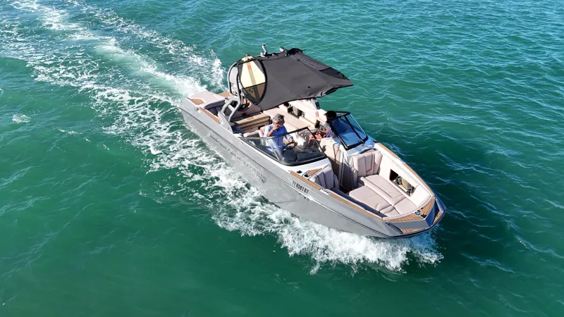 Slide: The Image of 2018 Nautique Super Air Nautique G25 cruising on clear blue water. - 5