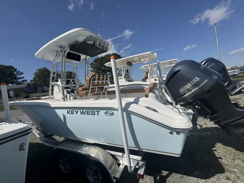 Slide: The Image of 2025 Key West 239 FS boat with Yamaha engine, parked on a trailer under a clear sky. - 0