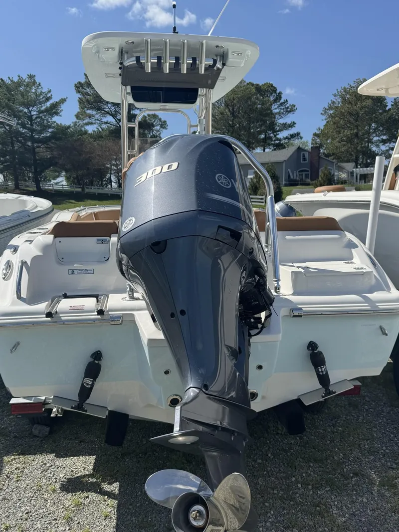 Slide: The Image of 2025 Key West 239 FS boat with powerful outboard motor, parked outdoors. - 1