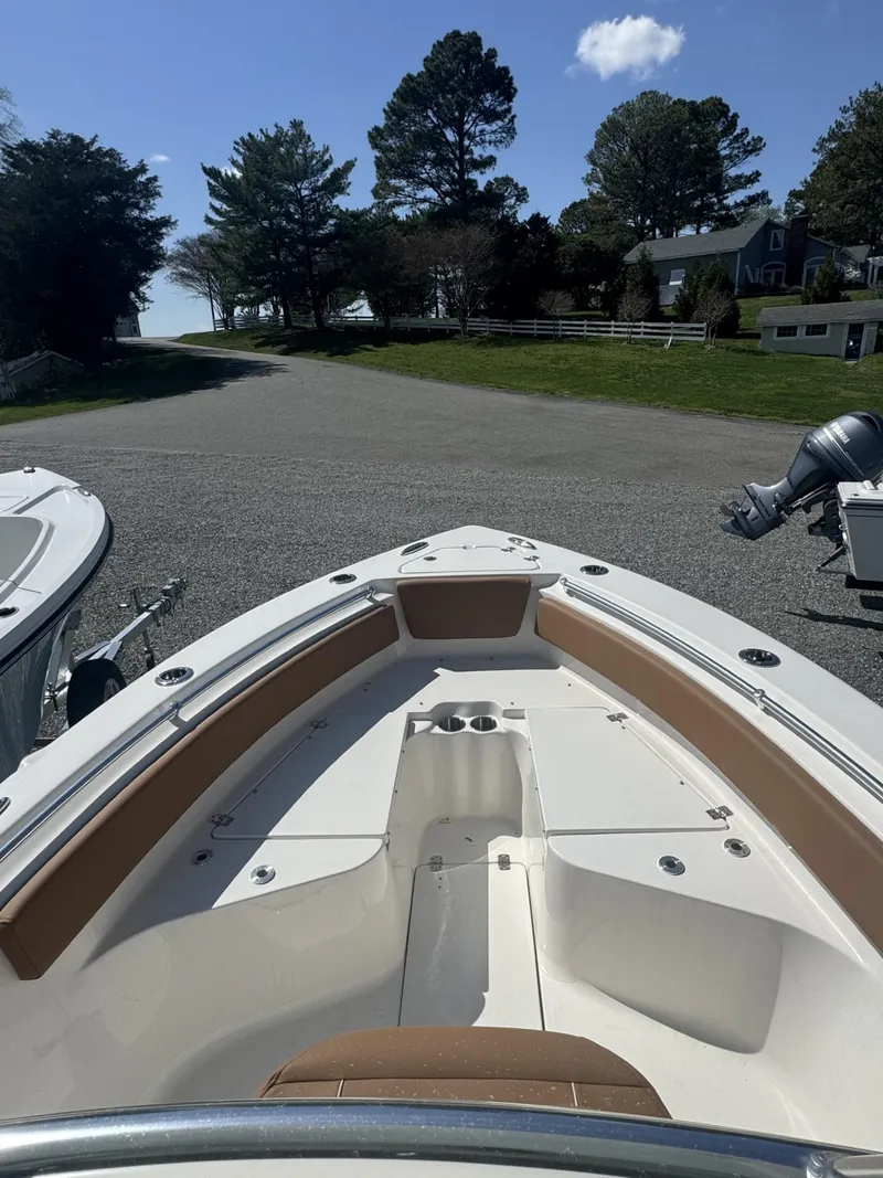 Slide: The Image of 2025 Key West 239 FS boat with spacious seating, docked outdoors under clear skies. - 5