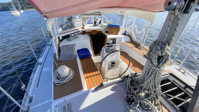 Slide: The Image of Cockpit view of 1990 Bruce Roberts 43 Mauritius sailboat, featuring steering wheel and nautical equipment. - 13
