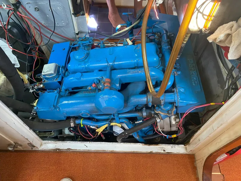 Slide: The Image of Blue engine inside a 1990 Bruce Roberts 43 Mauritius boat, surrounded by wiring and components. - 14
