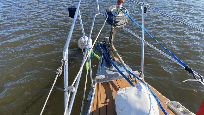Slide: The Image of Bow of 1990 Bruce Roberts 43 Mauritius sailboat with rigging and calm water. - 15