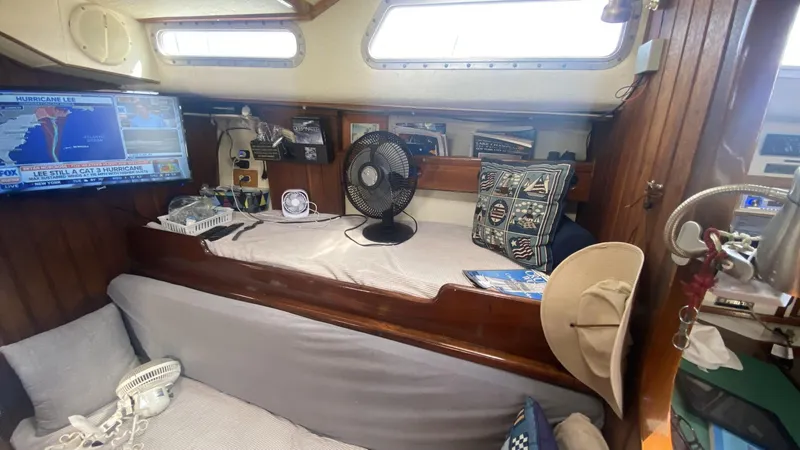 Slide: The Image of Cozy interior of 1990 Bruce Roberts 43 Mauritius sailboat with fan, TV, and nautical decor. - 16