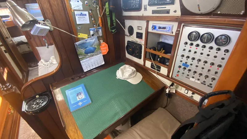 Slide: The Image of Interior of 1990 Bruce Roberts 43 Mauritius sailboat with navigation station and control panels. - 17