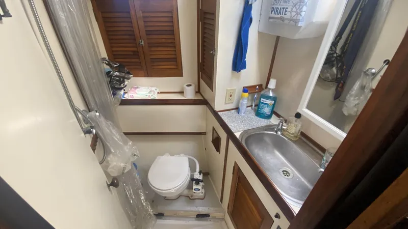 Slide: The Image of Bathroom of 1990 Bruce Roberts 43 Mauritius yacht with sink, toilet, and storage cabinets. - 18