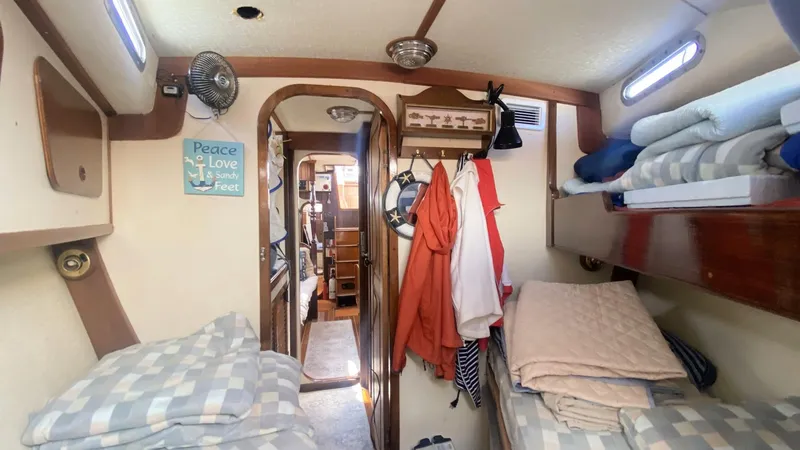 Slide: The Image of Interior of 1990 Bruce Roberts 43 Mauritius sailboat cabin with cozy bedding and nautical decor. - 19