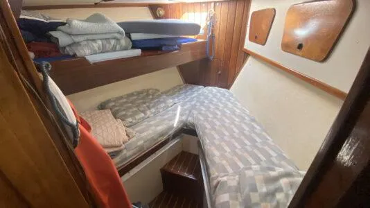 Slide: The Image of Cozy cabin interior of 1990 Bruce Roberts 43 Mauritius sailboat with bunk beds and wooden paneling. - 20