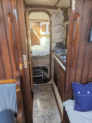 Slide: The Image of Interior of 1990 Bruce Roberts 43 Mauritius sailboat with wooden paneling and cozy cabin. - 22