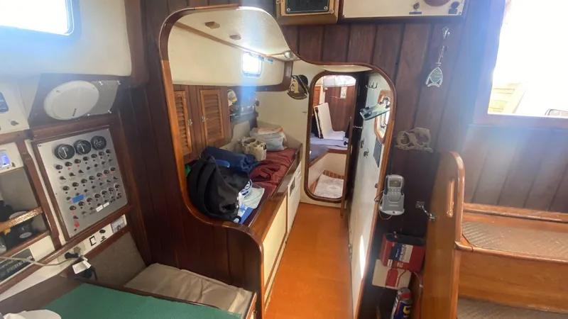 Slide: The Image of Interior of 1990 Bruce Roberts 43 Mauritius sailboat with wood paneling and navigation controls. - 8