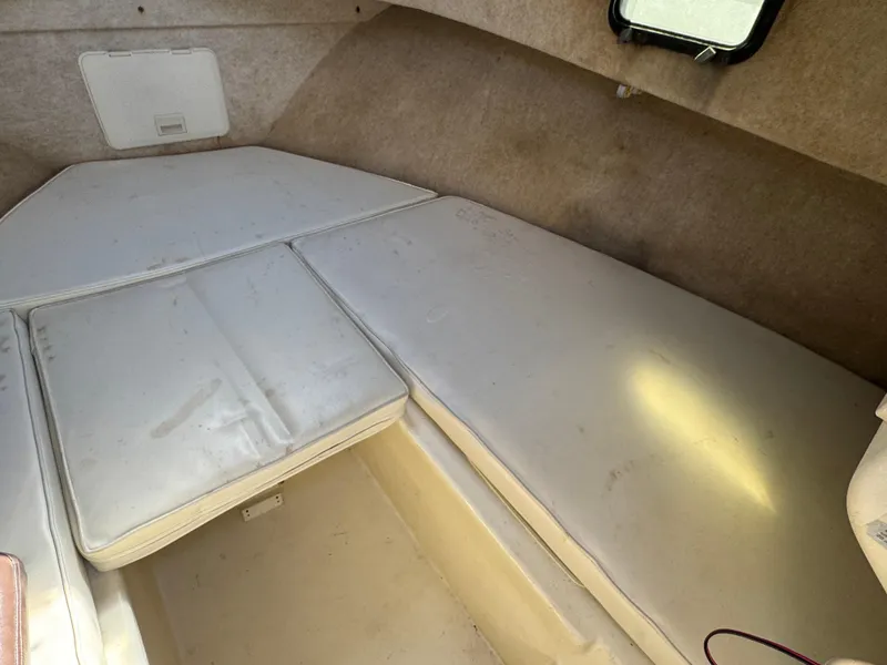 Slide: The Image of Interior cabin of a 2000 Parker 2110 Walkaround boat with cushioned seating. - 10