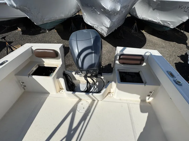 Slide: The Image of 2000 Parker 2110 Walkaround boat with outboard motor and storage compartments. - 6