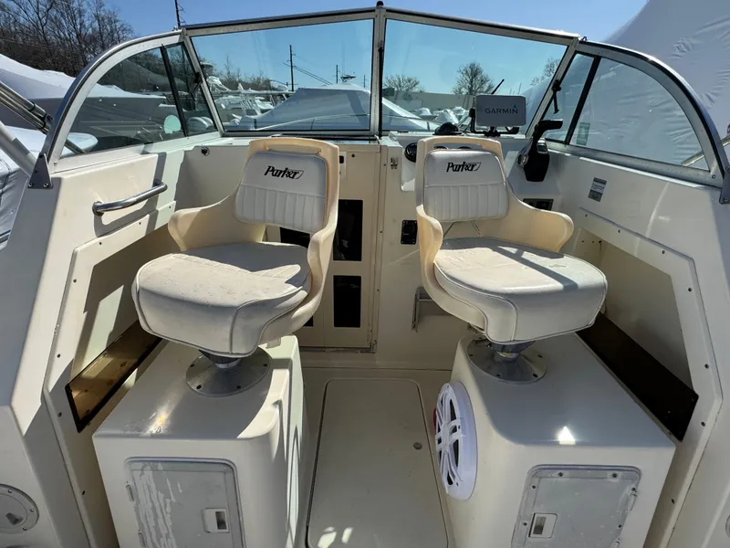 Slide: The Image of 2000 Parker 2110 Walkaround boat interior with two white captain chairs. - 7