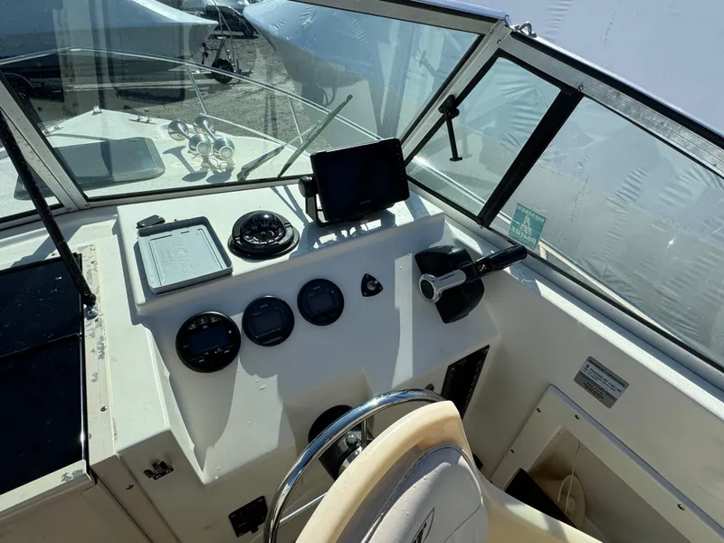 Slide: The Image of 2000 Parker 2110 Walkaround boat dashboard with steering wheel and navigation instruments. - 8