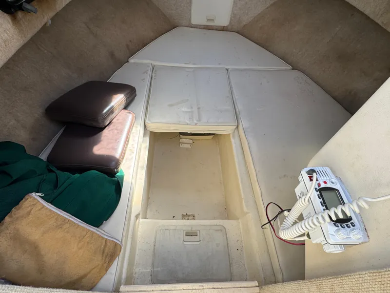 Slide: The Image of 2000 Parker 2110 Walkaround cabin interior with cushions and radio equipment. - 9